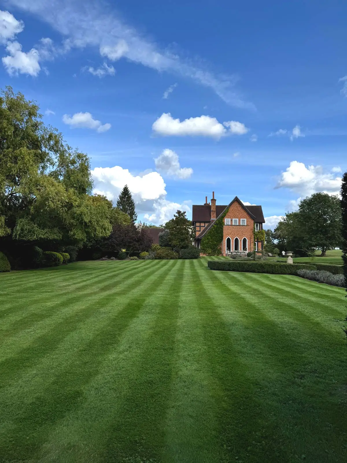 Freshly mown striped lawn at a period property in Weybridge, Surrey